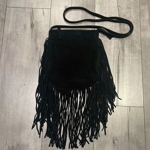 Boho leather Crossbody bag with long tassels. Made by lost & found brand. ￼